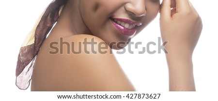 Close-up lips and hair of smiling African woman with sparkle crimson lips, ethnic shawl and perfect skin. Isolated on white background. Toned