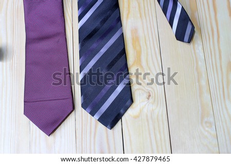 Happy Fathers Day with red, gray and black striped necktie on pime wood background