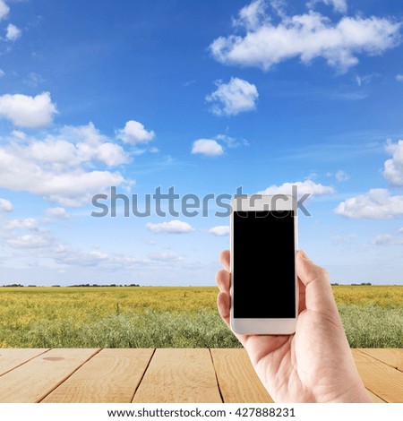 Hand using mobile smartphone in vertical position, blurred background - mockup template