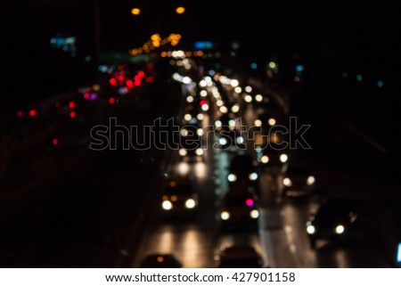 abstract traffic jams night light with cross process filter background with blurry shallow depth of focus.