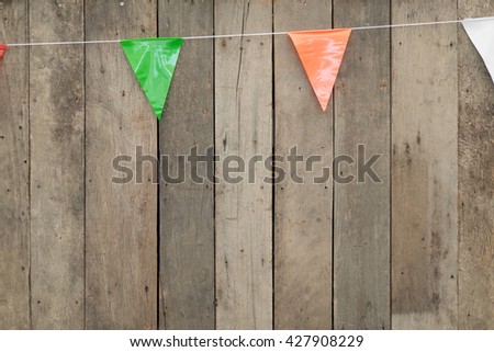 Wooden wall with colorful triangle pennant flag banners - outdoor party backdrop