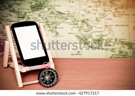 mobile phone and compass with blur part of world map,color filter tone background