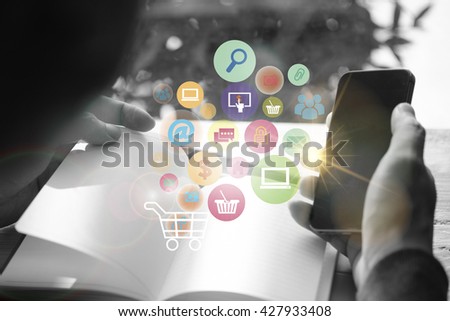 shopping cart with application software icons on mobile ,black and white background image business concept, shopping online concept , business idea,online shopping, marketing online,