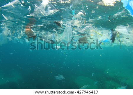 Plastic rubbish pollution in ocean environment Royalty-Free Stock Photo #427946419