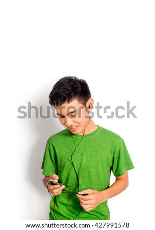 A boy in green shirt listens to music.