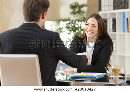 Businesspeople handshaking after negotiation or interview at office Royalty-Free Stock Photo #428013427