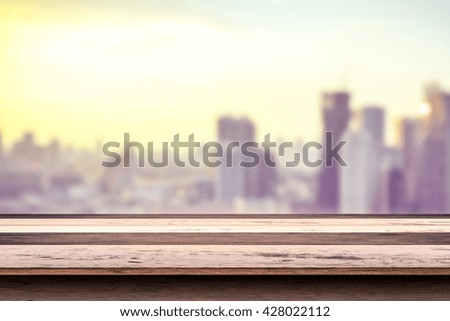 wooden floor in front of abstract color bokeh background