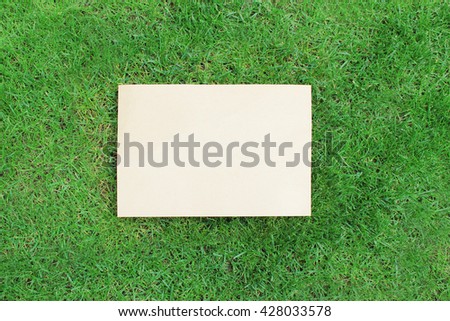 paper sheet on green lush grass 
