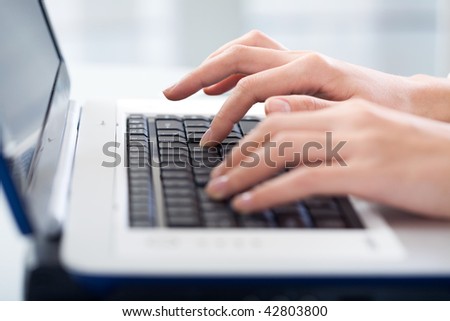Photo of female hands typing a letter on the laptop