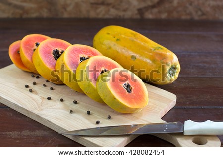 Papaya dissect and slice on wooden block / Image Selective focus
