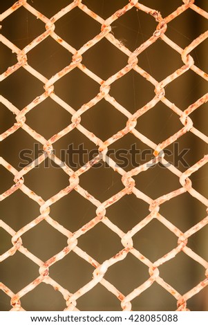 Rusty metal net fence 