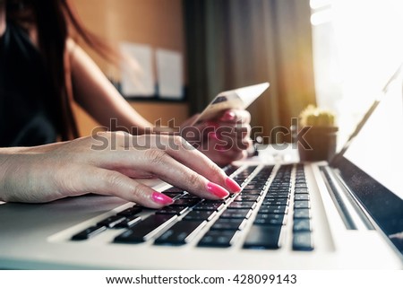 woman hands using laptop and holding credit card with social media as Online shopping concept in morning light
