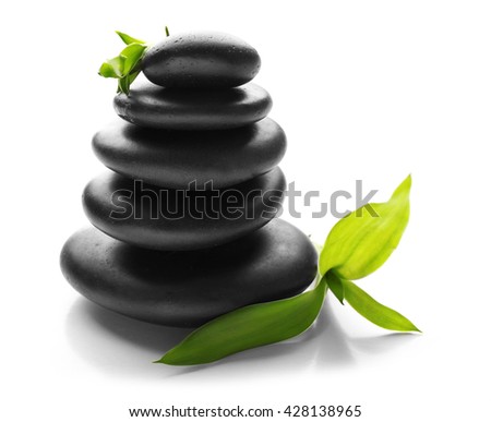 Stack of spa hot stones isolated on white background Royalty-Free Stock Photo #428138965