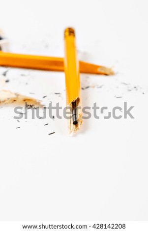Broken pencil with shavings on white background. Vertical image.