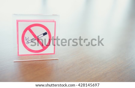 No smoking sign in Lobby on the wooden table.