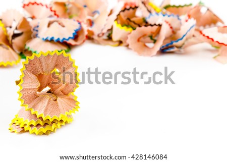 Yellow pencil shavings with more shavings at the background. Horizontal image.