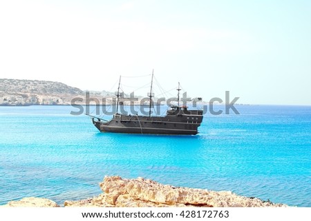 pirate sailing ship on the background of bright blue sea and sky
