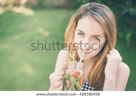 Young girl drinking tasty cocktail , outdoor terrace.