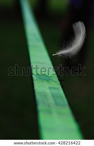Slackline and a feather in the air