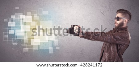 A funny stylish hipster guy capturing bright moments and glowing square pictures with a vintage photo camera illustration concept