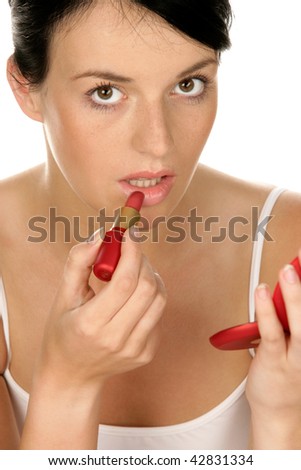 Portrait of young woman applying lipstick