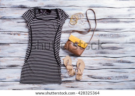 Striped black dress and sandals. Beige sandals with dark dress. Casual summer outfit for girls. High quality apparel in stock.
