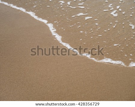 Soft wave of sea on sandy beach. Background. soft focus