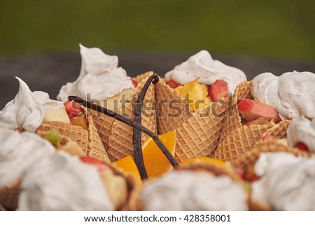                                 ice cream cones filled with fruit salad with whipped cream 