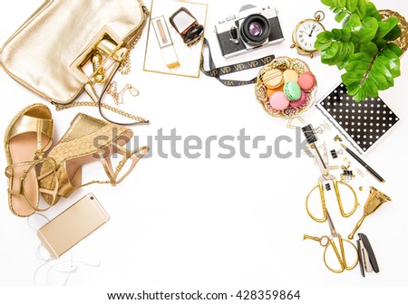 Fashion flat lay for bloggers social media. Feminine golden accessories, bag, shoes, office supplies, vintage photo camera and green plant on white background. Shopping. Social media flat lay