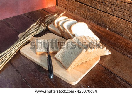 Cutting bread on wood background still life style
