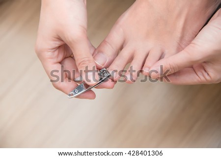 closeup of a woman cutting nails Royalty-Free Stock Photo #428401306