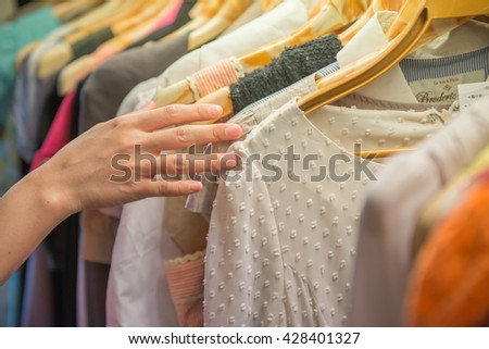 Young beautiful women shopping in fashion mall, choosing new clothes Royalty-Free Stock Photo #428401327