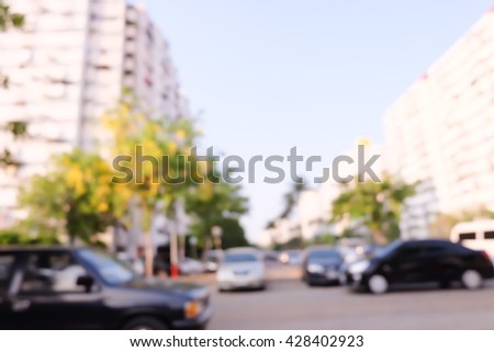 blurred car in parking lot ,city background.