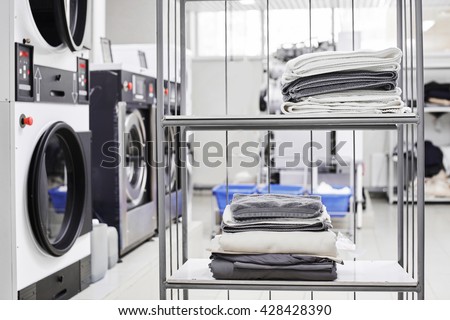 Clean stuff is on the rack at the dry cleaners Royalty-Free Stock Photo #428428390