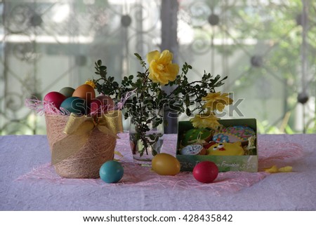 cookies in a box and painted Easter eggs in a basket
