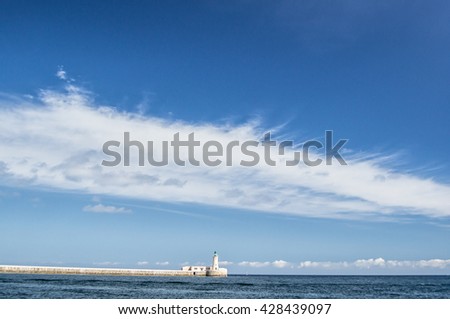 Marine beacon at Malta. Fantastically beautiful clouds and ocean water