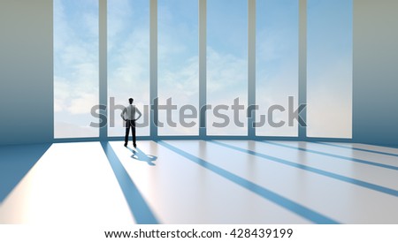 Businessman standing by the window in an empty room