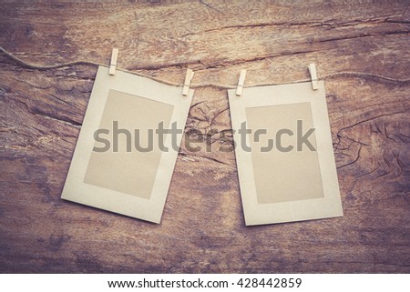 picture frame paper hanging on a rope that are old wood background