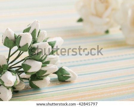 closeup shot of spring paper flowers on green background