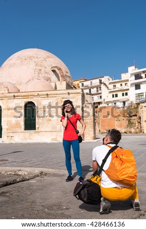 guy taking a picture of the girl in front of the cathedral