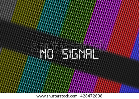 Closeup pixels of LCD TV screen with color bars and message no signal is a television test pattern