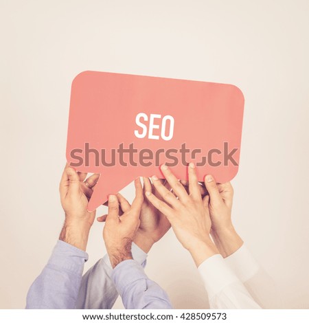 A group of people holding the SEO written speech bubble
