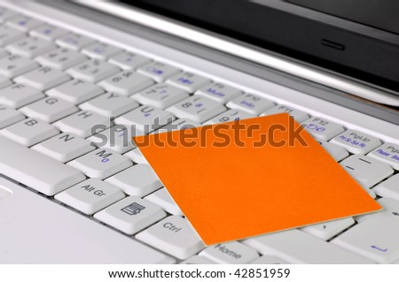 Modern laptop with blank card on it
