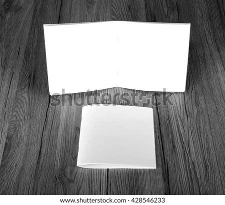 Blank catalog, brochure, magazines, book on wooden background, top view