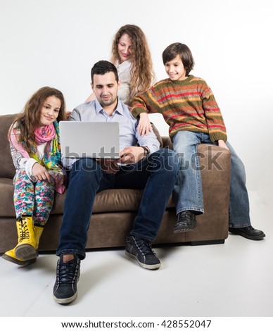 Family at home sitting at sofa