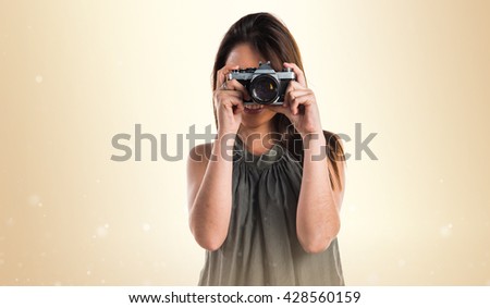 Young girl holding a camera
