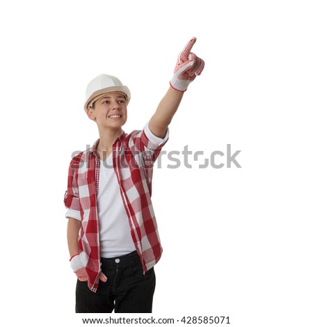 Cute teenager boy in red checkered shirt and building helmet pointing up side over white isolated background, half body, constructing concept
