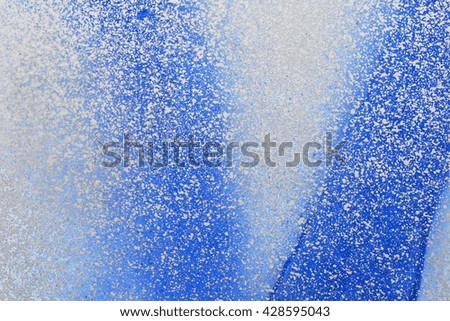Splashes of  blue white paint on the wall. Colored textured background
