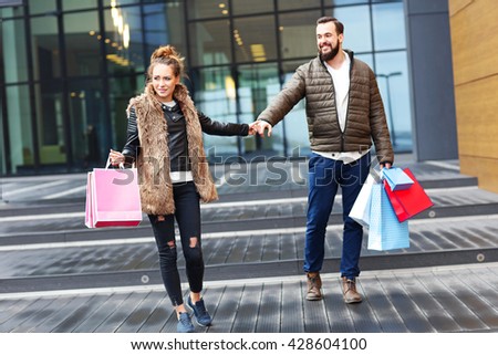 Picture of young couple with shopping bags in the city
