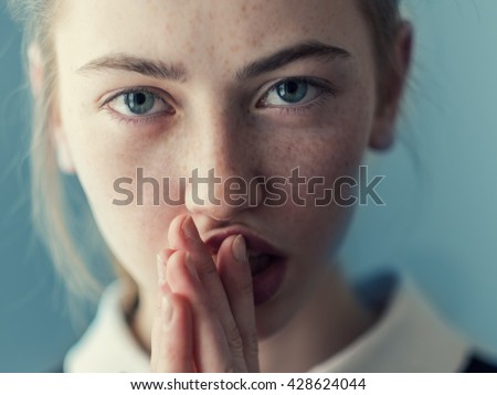 beautiful girl with freckles crying Royalty-Free Stock Photo #428624044